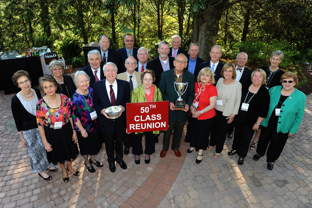 A large group gathered outdoors celebrating a class reunion