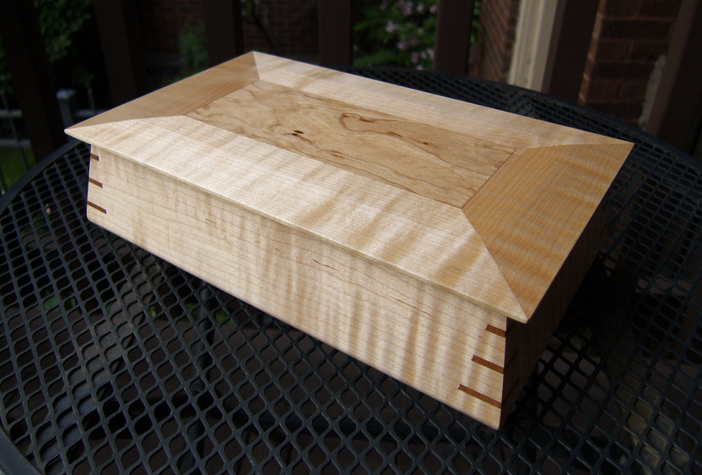 A wooden keepsake box holding small mementos